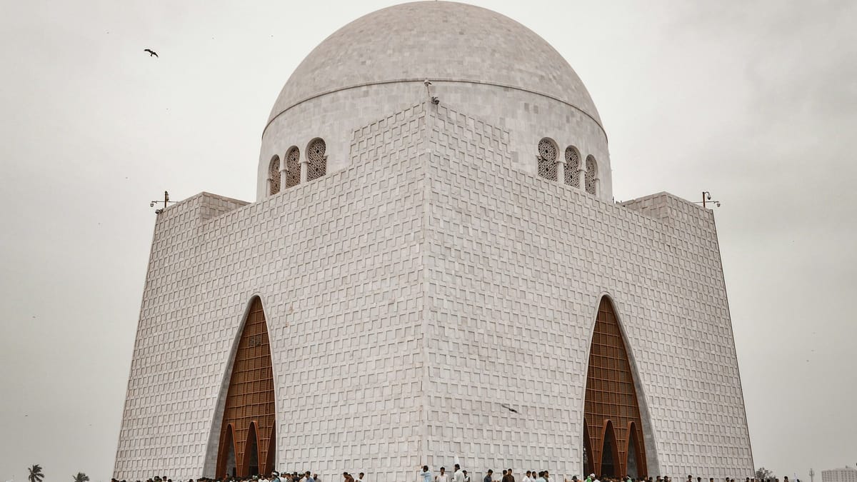 People walking near white concrete building during daytime.
